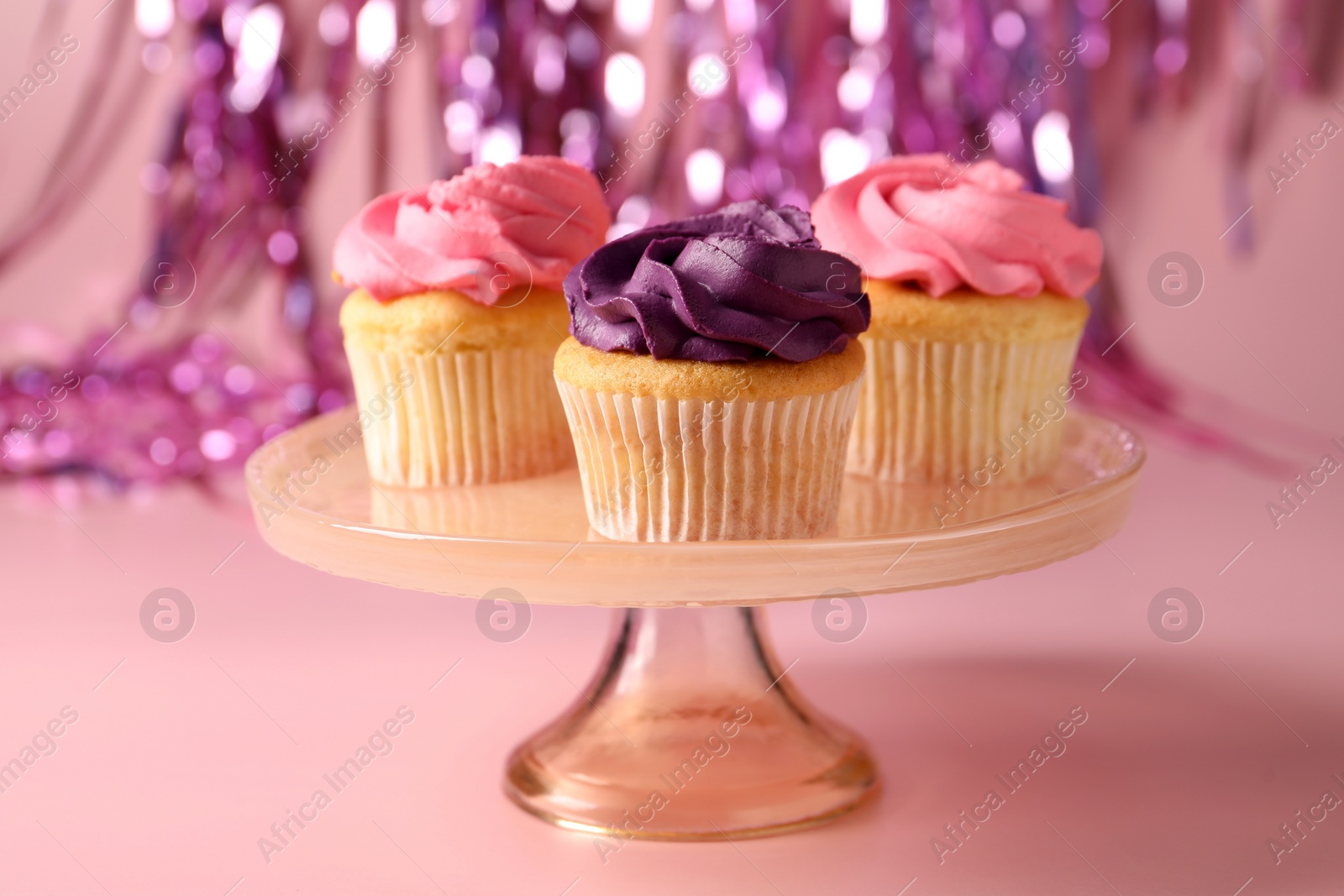 Photo of Delicious cupcakes with bright cream on pink background