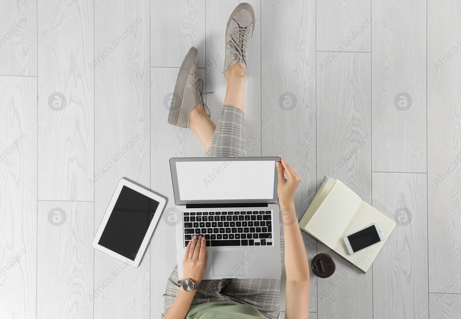 Photo of Top view of woman with laptop sitting on floor, closeup. Mockup for design