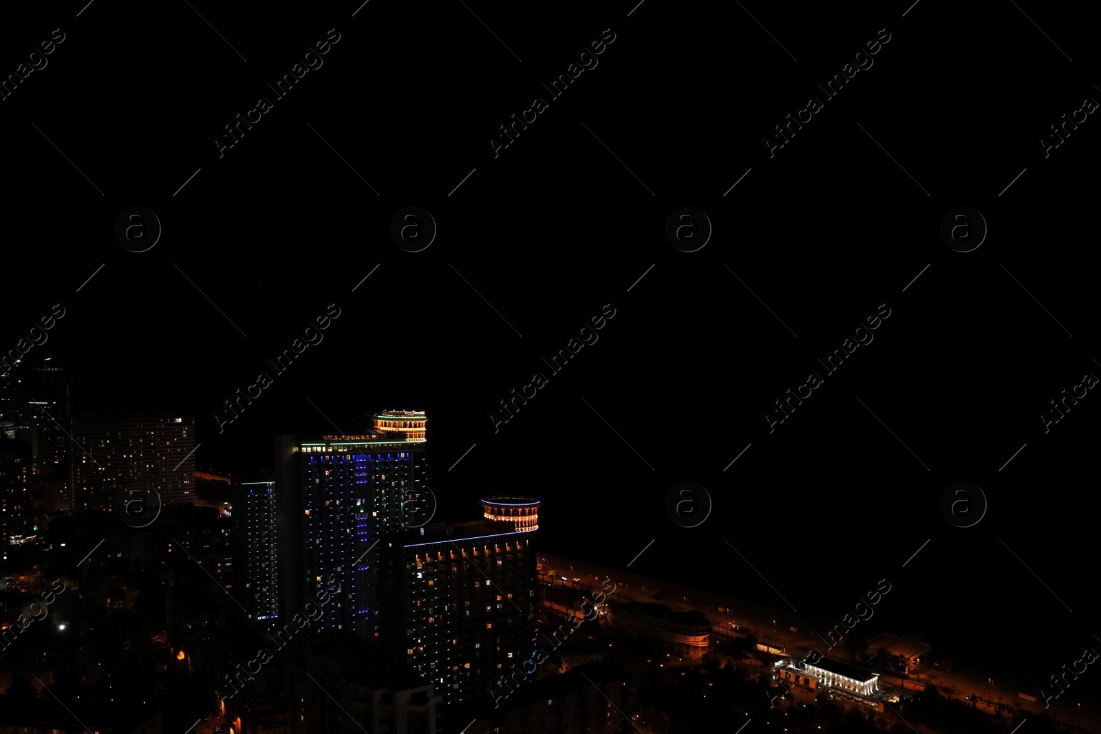 Photo of Picturesque view of city with buildings at night. Space for text