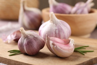 Photo of Bulbs and cloves of fresh garlic on table, closeup