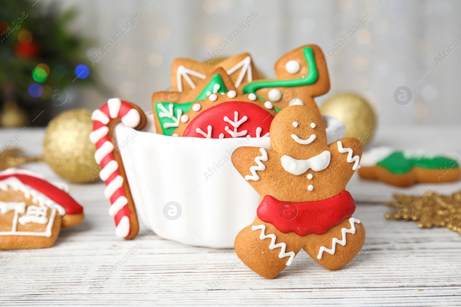 Photo of Bowl with tasty homemade Christmas cookies on table