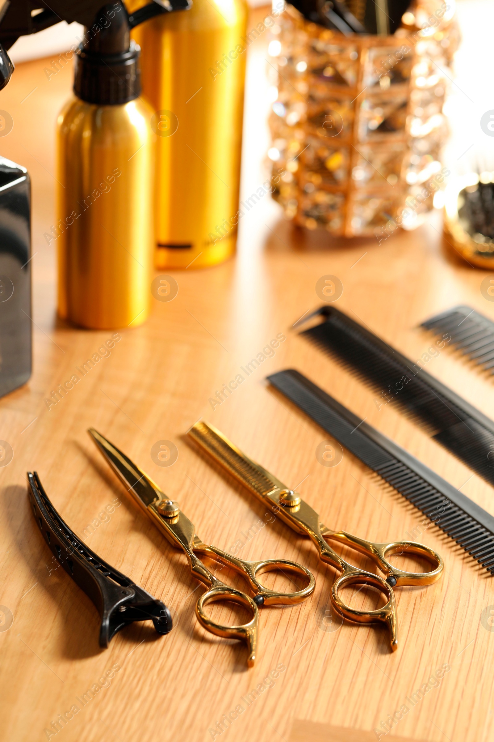 Photo of Hairdresser tools. Different scissors and combs on wooden table, closeup