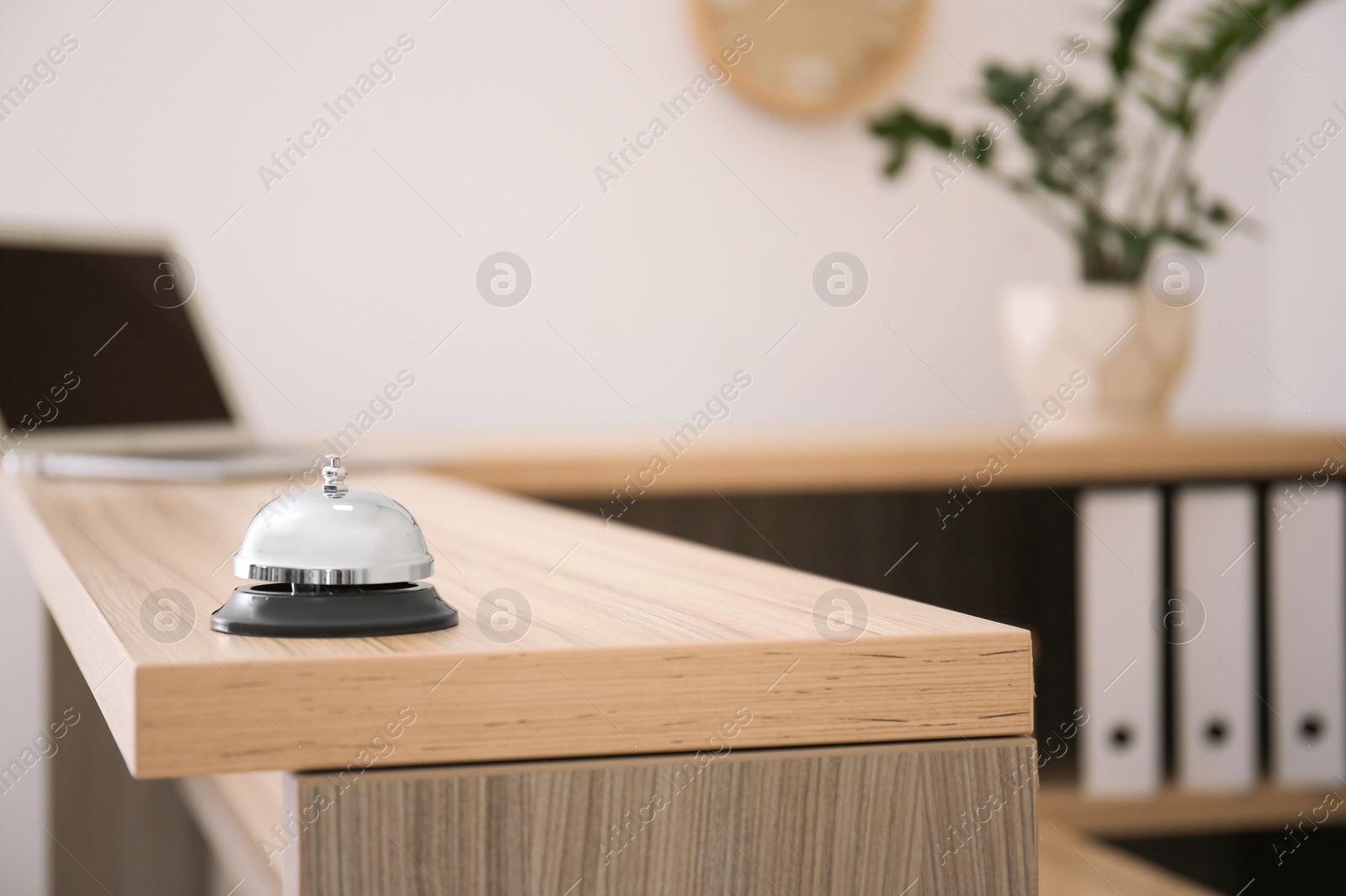 Photo of Service bell on reception desk in hotel, closeup