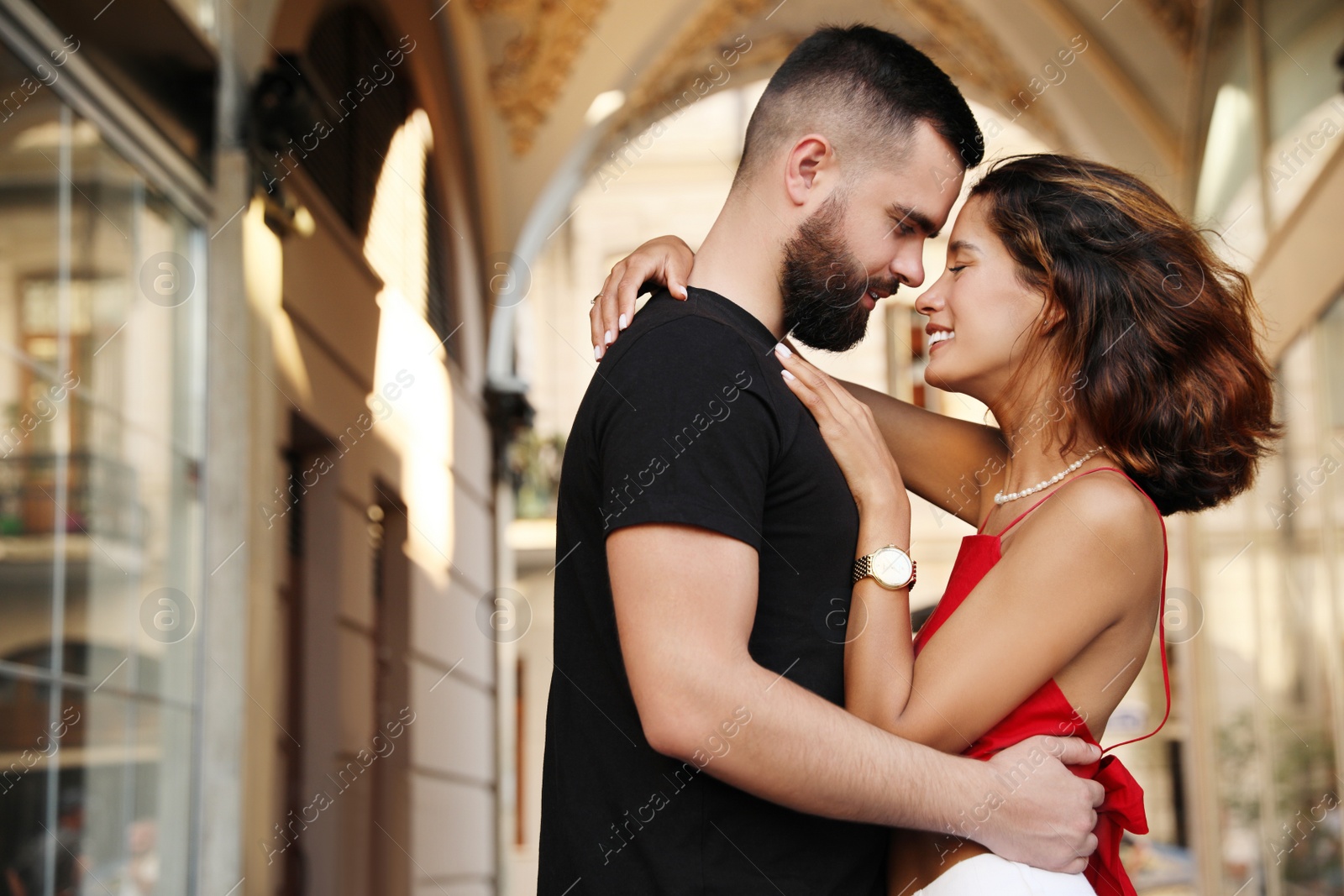 Photo of Happy young couple hugging on city street