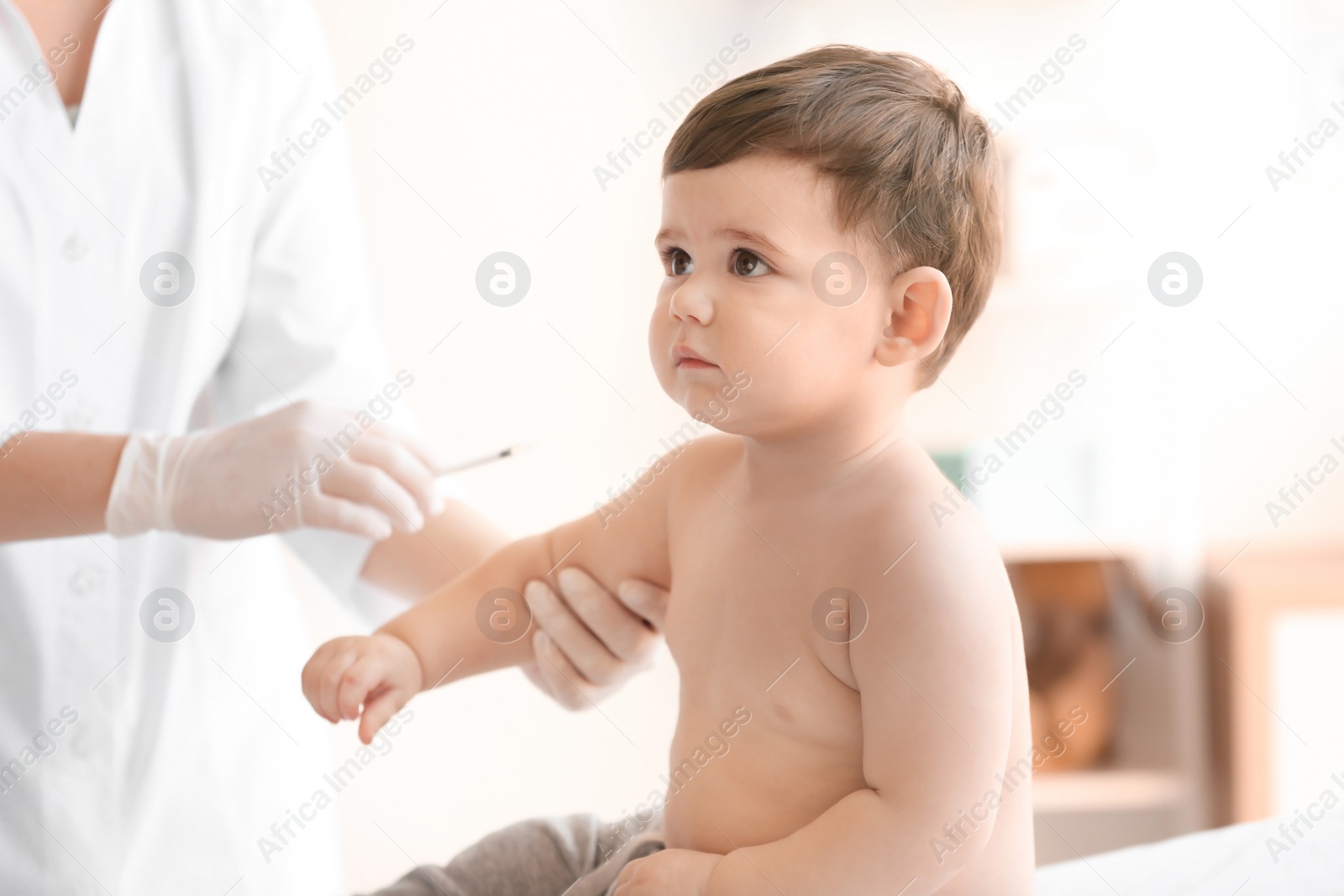 Photo of Doctor vaccinating baby in clinic