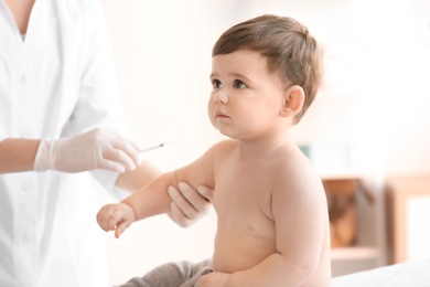 Photo of Doctor vaccinating baby in clinic