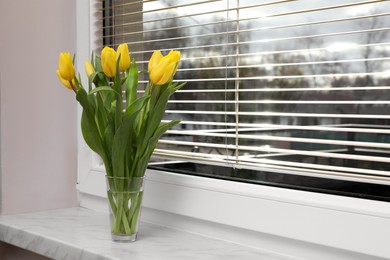 Photo of Wonderful tulips on window sill indoors, space for text. Spring atmosphere