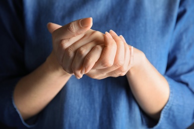 Photo of Woman showing word believe, closeup. Sign language