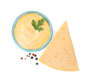 Photo of Tasty cheese, sauce with parsley and peppercorns on white background, top view
