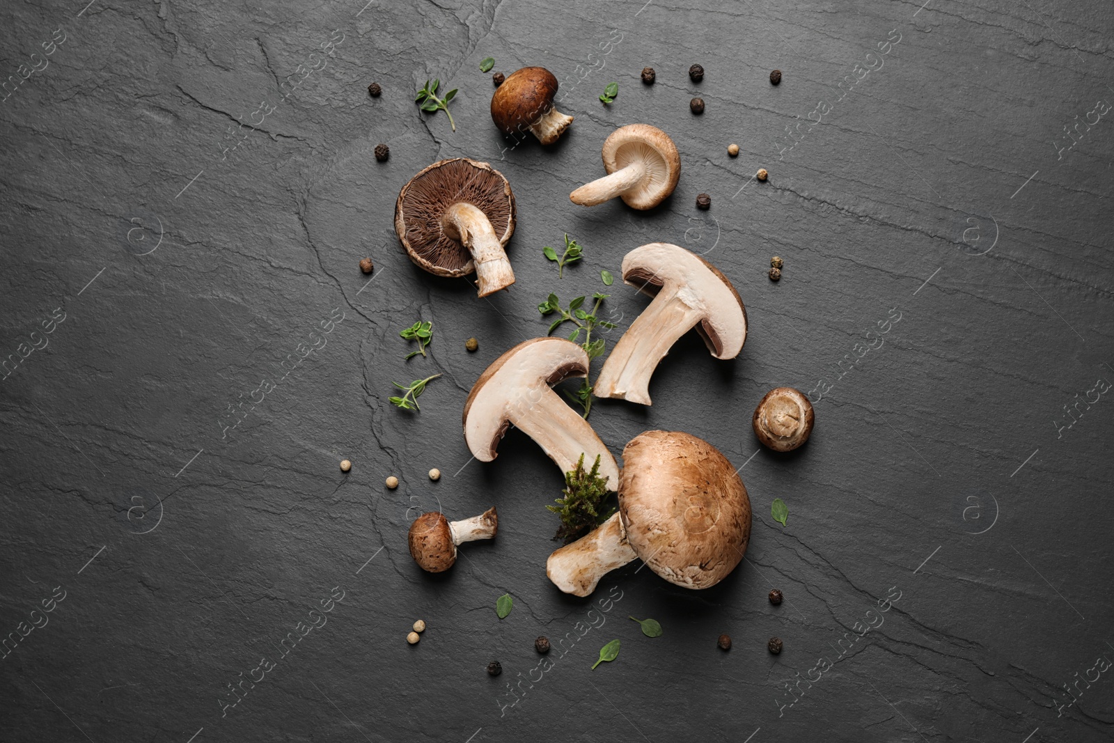 Photo of Flat lay composition with fresh wild mushrooms on black table