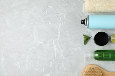 Photo of Flat lay composition with natural deodorant and bath accessories on light grey marble table. Space for text
