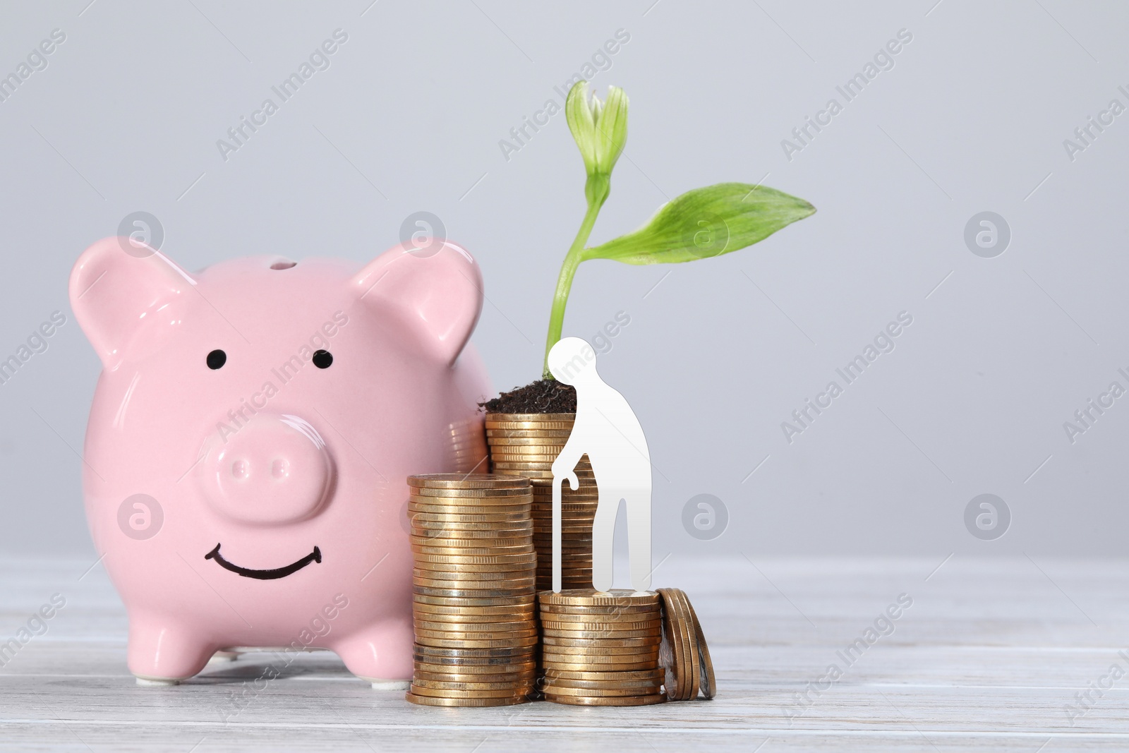 Image of Pension concept. Elderly man illustration, piggybank, coins and sprout on white wooden table. Space for text