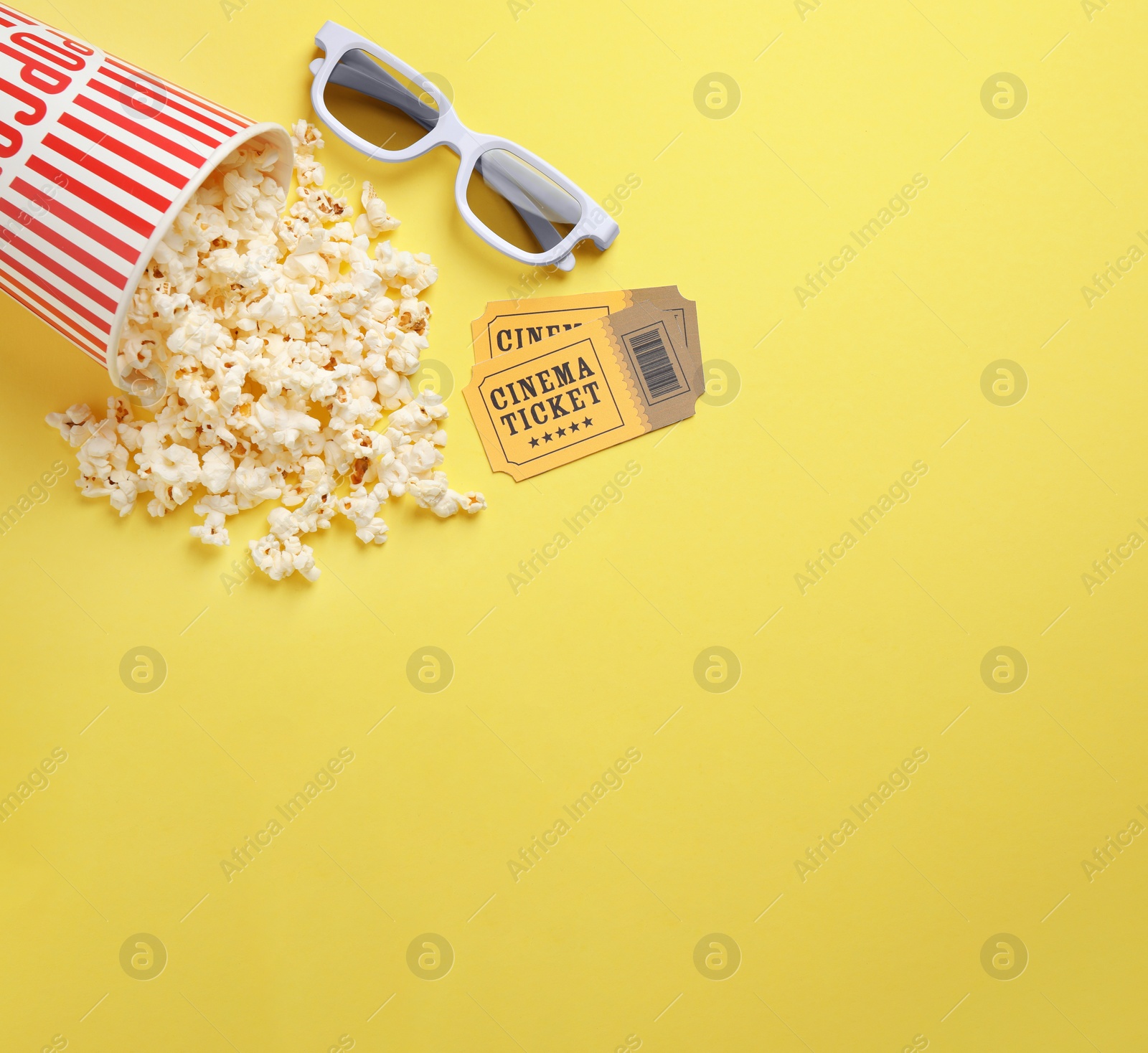 Photo of Flat lay composition with delicious popcorn on yellow background. Space for text