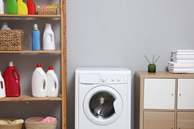 Photo of Laundry room interior with washing machine and furniture