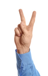 Photo of Young man showing victory gesture on white background