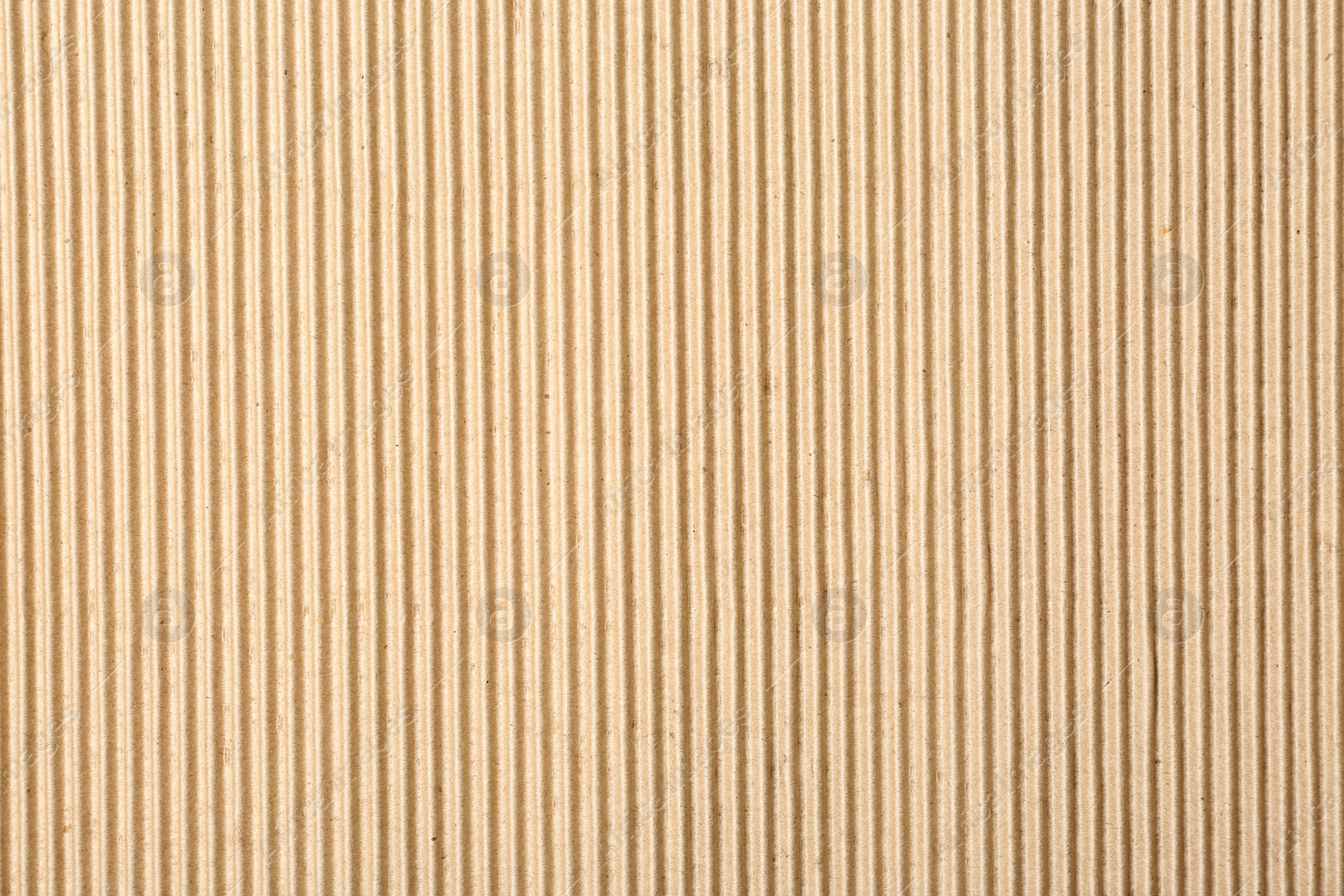 Photo of Corrugated cardboard surface as background, top view. Recyclable material