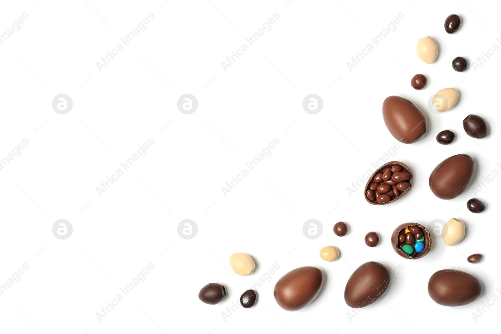 Photo of Flat lay composition with chocolate Easter eggs and space for text on white background