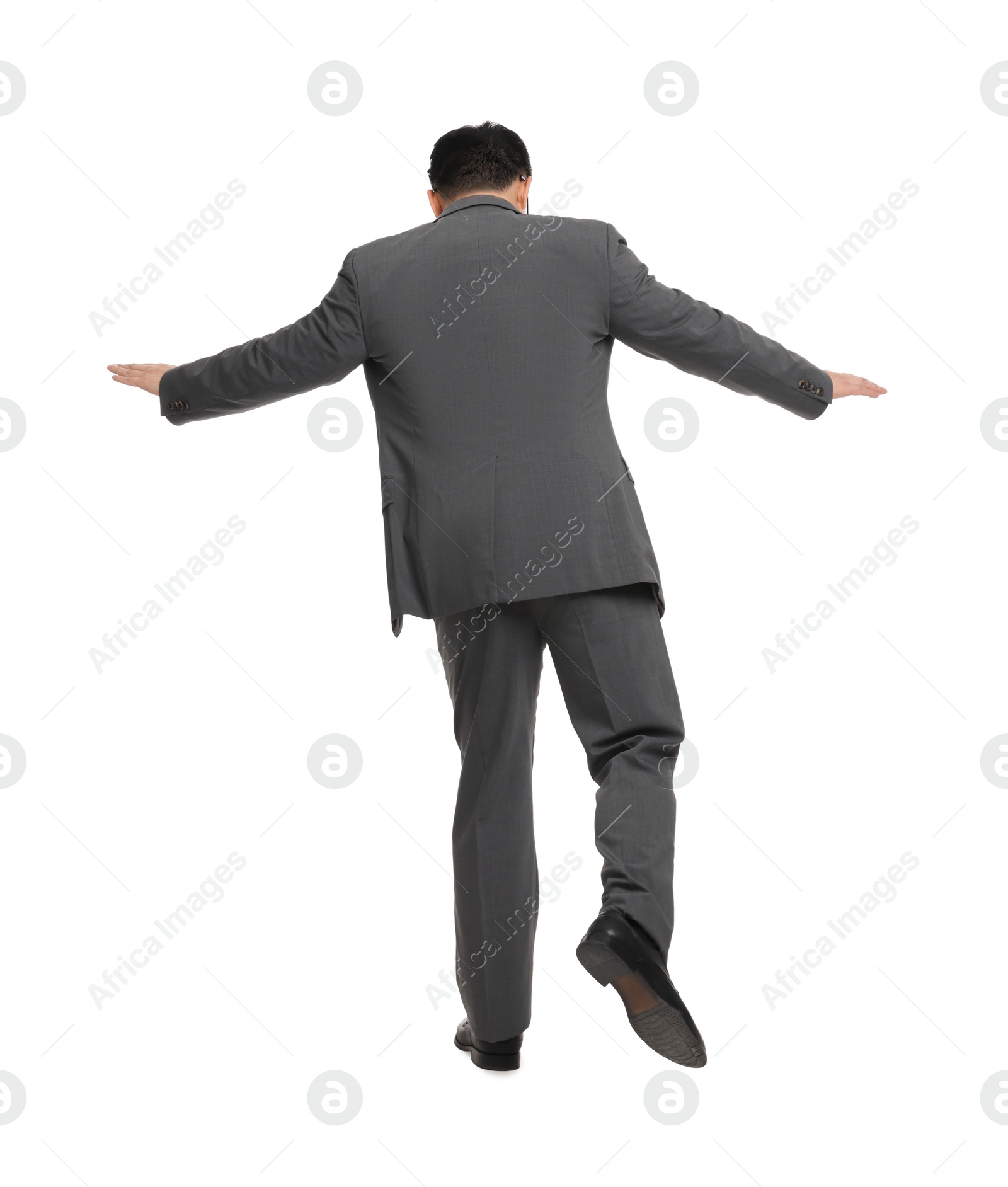 Photo of Businessman in suit posing on white background, back view