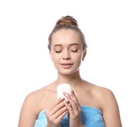 Young woman with soap bar on white background