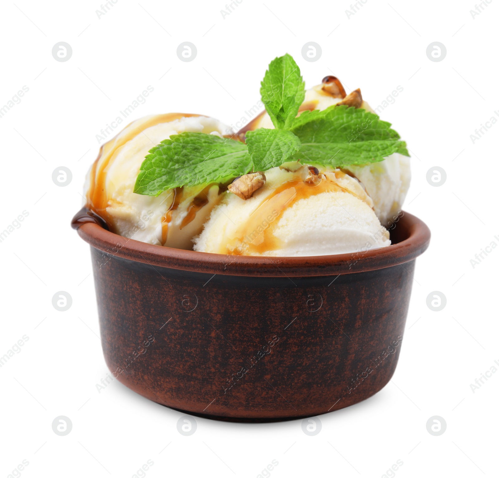 Photo of Tasty ice cream with caramel sauce, mint and nuts in bowl isolated on white