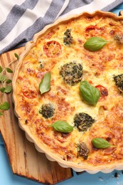 Delicious homemade vegetable quiche on table, top view