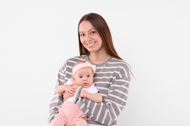 Happy mother with her cute baby on light background