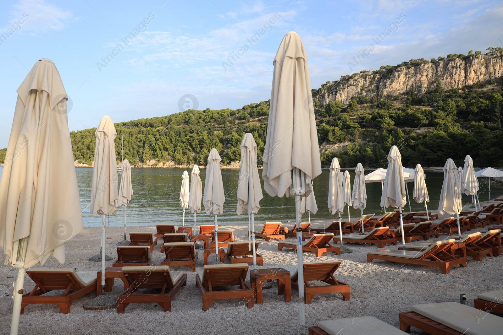 Photo of Many beach umbrellas and sunbeds at resort