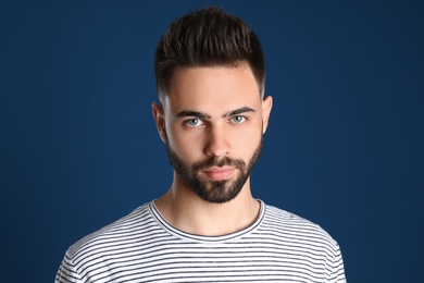 Photo of Portrait of handsome young man on color background