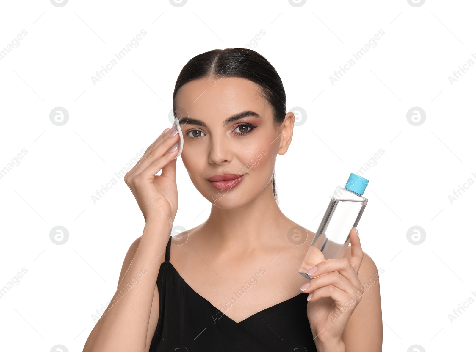 Photo of Beautiful woman removing makeup with cotton pad on white background