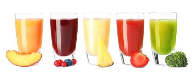 Photo of Glasses of delicious juices and fresh ingredients on white background