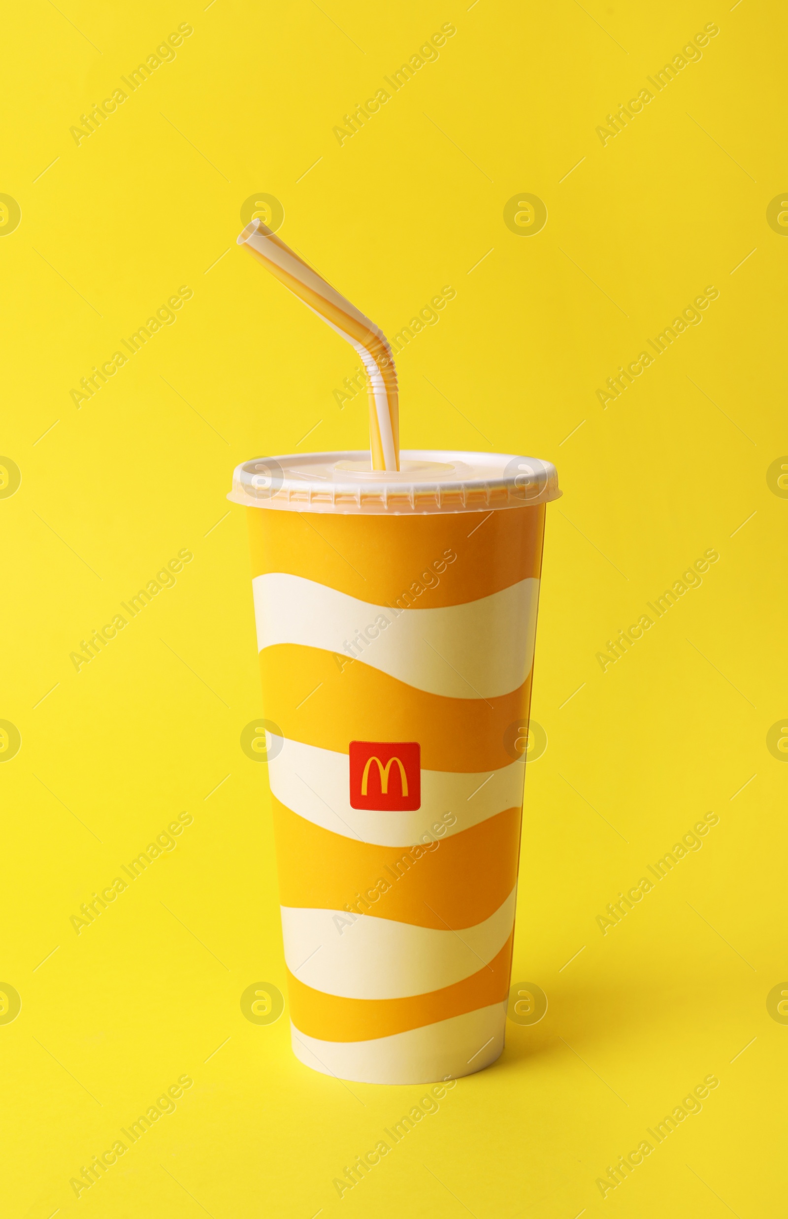 Photo of MYKOLAIV, UKRAINE - AUGUST 12, 2021: Cold McDonald's drink on yellow background