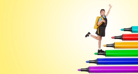 Happy schoolgirl going up on felt tip pens against yellow background. Way to knowledge. Banner design with space for text