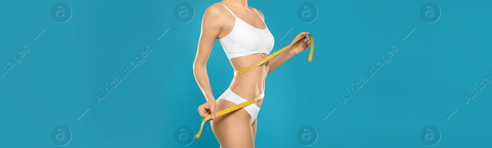 Image of Slim woman in underwear with measuring tape on color background, closeup. Banner design