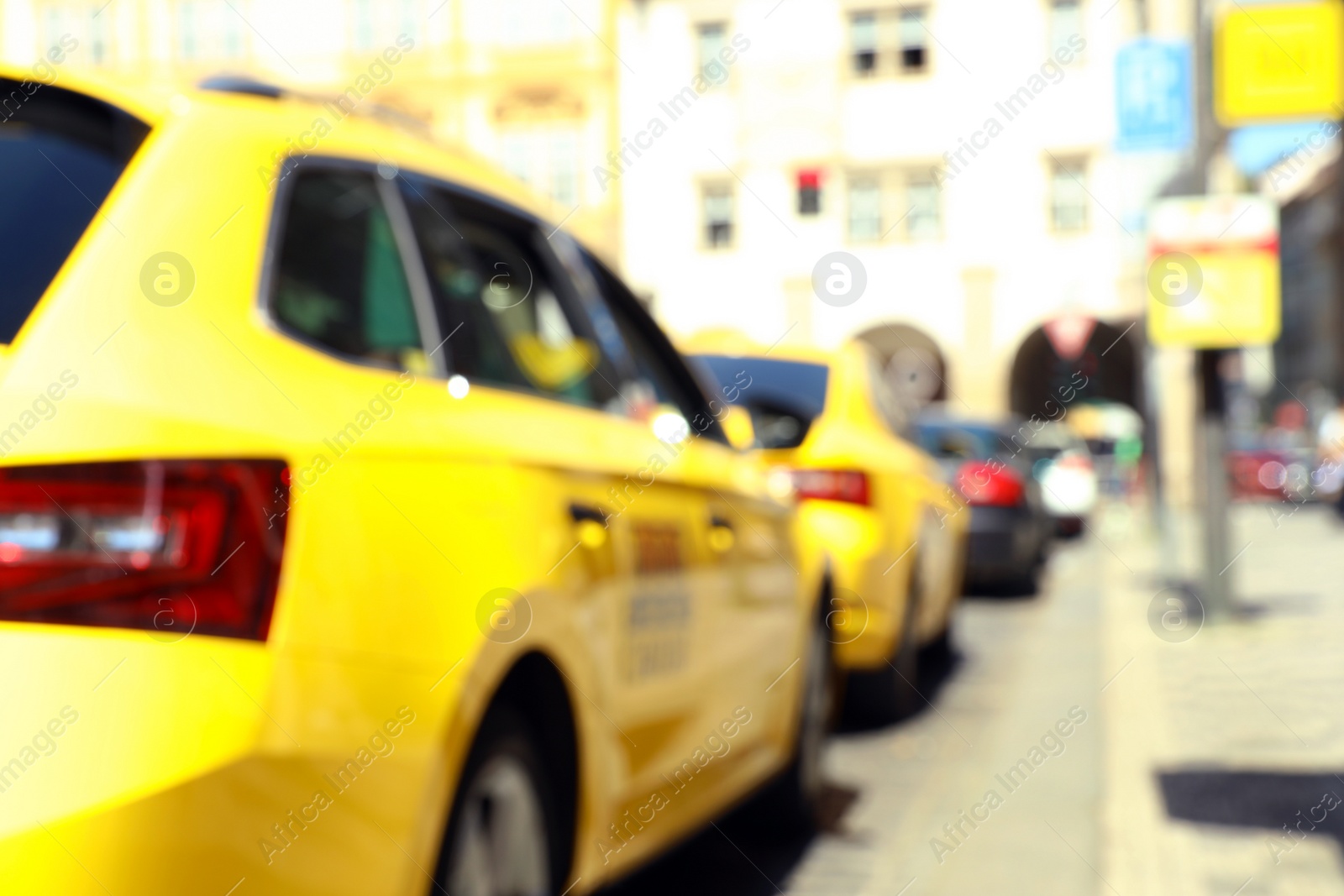 Photo of PRAGUE, CZECH REPUBLIC - APRIL 25, 2019: Blurred view of taxi parked on city street