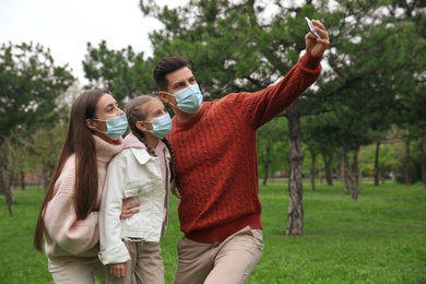 Lovely family taking selfie together in park during coronavirus pandemic