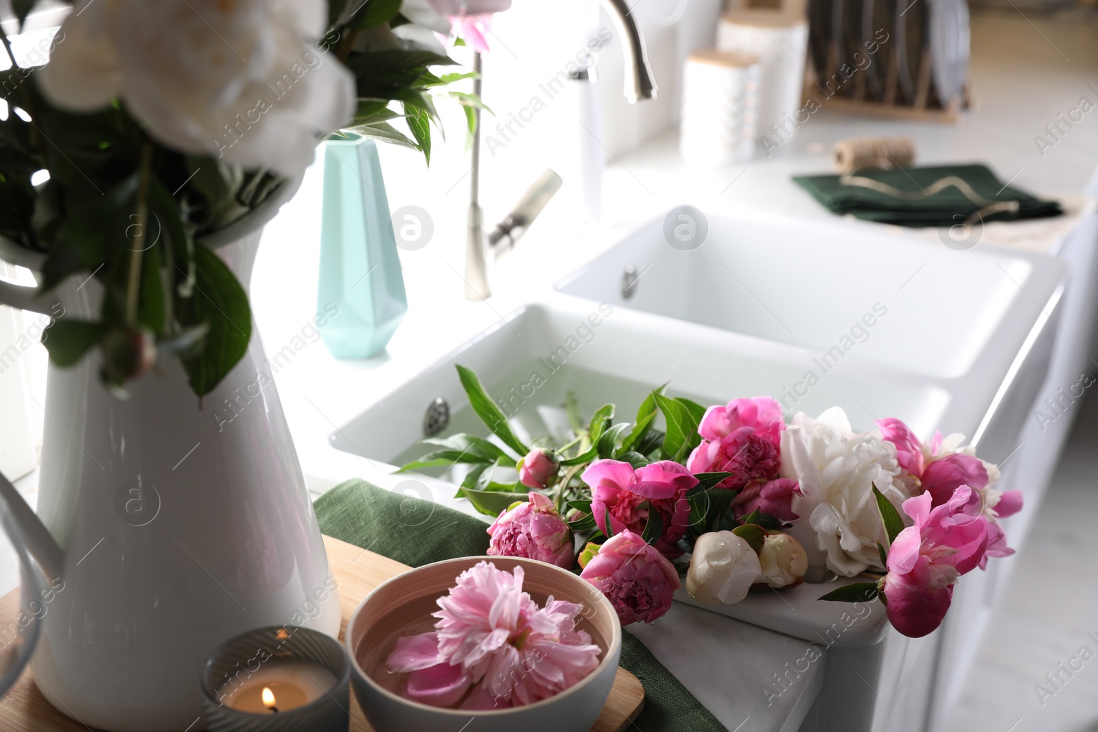 Photo of Bunch of beautiful peonies in kitchen sink