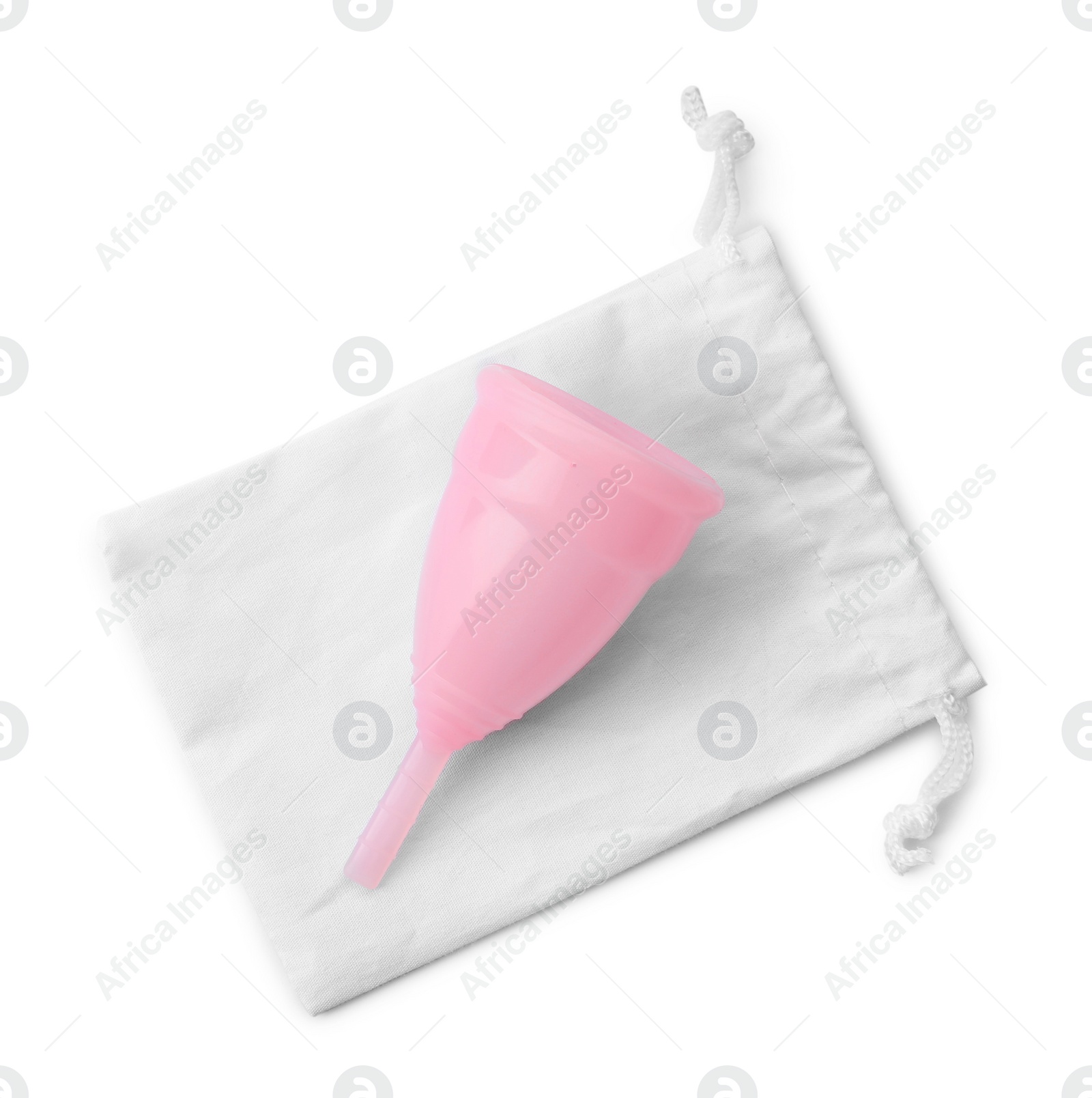 Photo of Pink menstrual cup with cotton bag on white background, top view