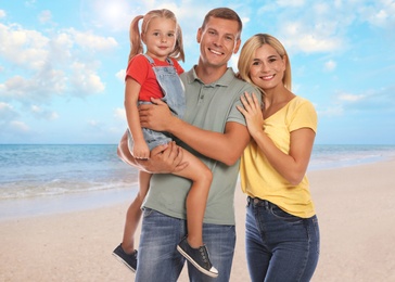 Image of Happy family on sandy beach near sea. Summer vacation