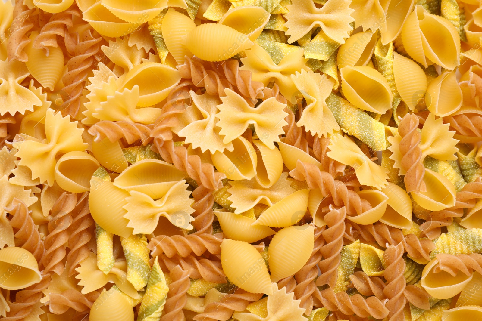 Photo of Different types of pasta as background, top view