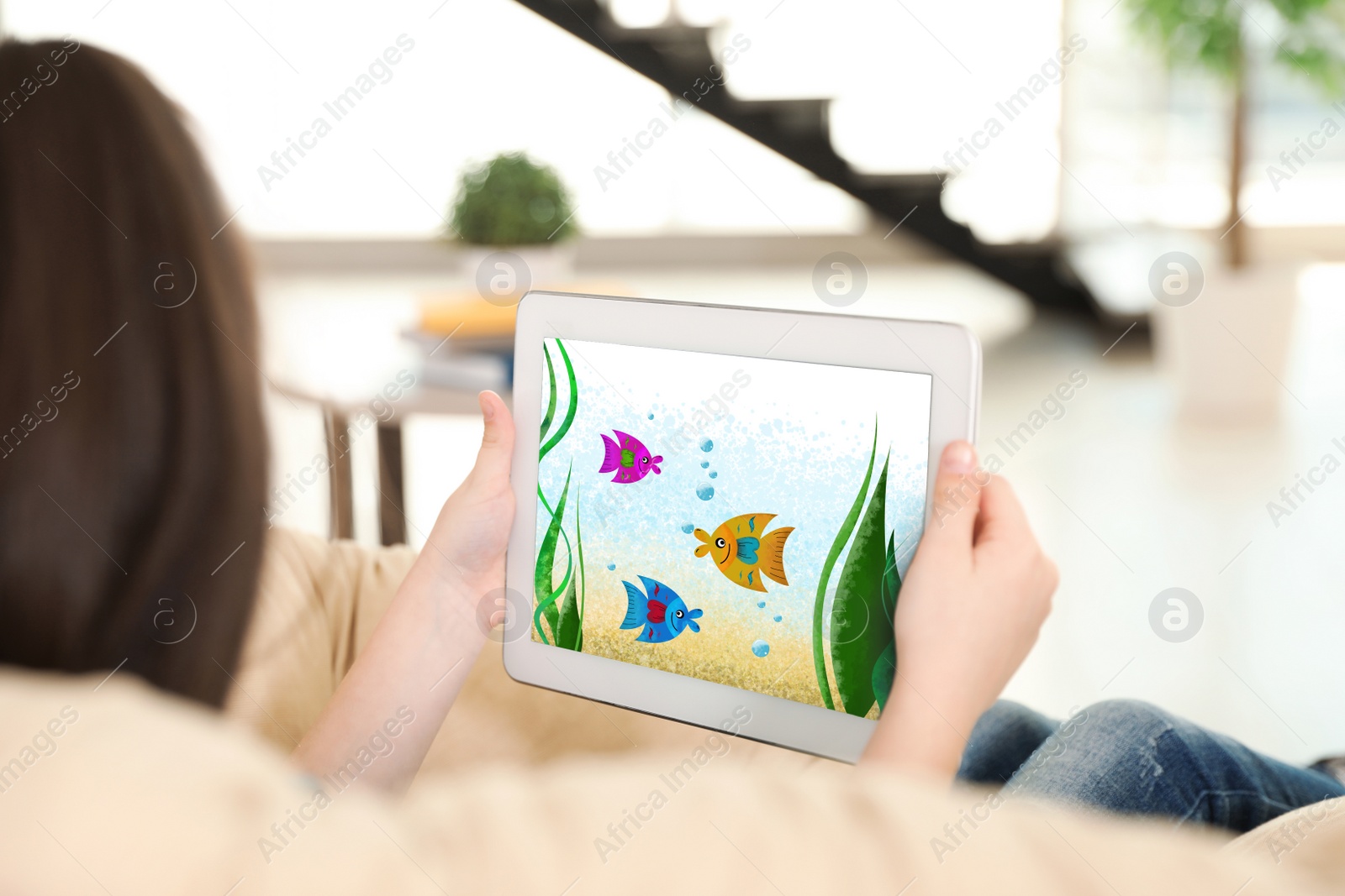 Image of Little girl holding tablet with cute drawing at home. Child art