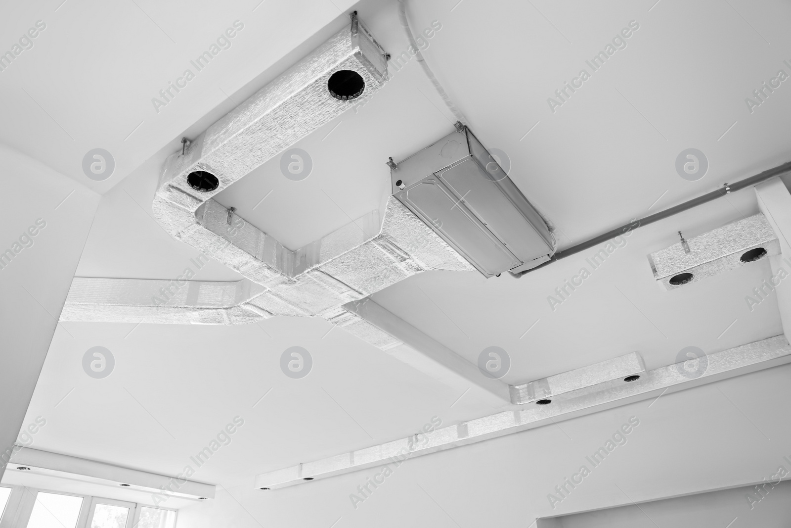 Photo of Ceiling with ventilation system indoors, low angle view