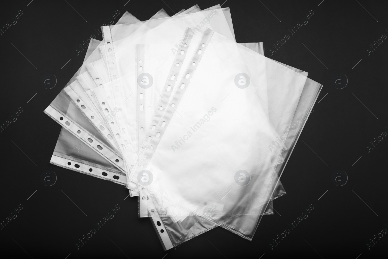 Photo of Punched pockets on black background, flat lay