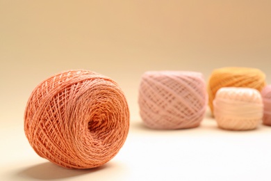 Photo of Clews of knitting threads on color background, space for text. Sewing stuff