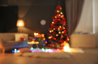 Photo of Blurred view of stylish room interior with decorated Christmas tree