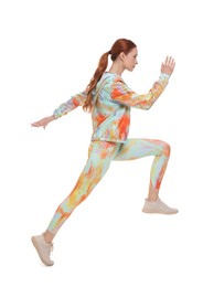 Photo of Young woman in sportswear jumping on white background