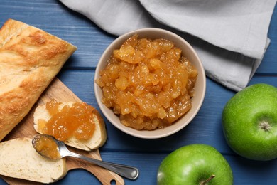 Photo of Flat lay composition with delicious apple jam on blue wooden table