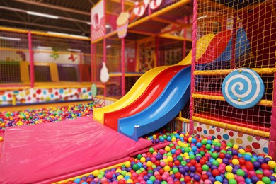 Photo of Slides and many colorful balls in ball pit