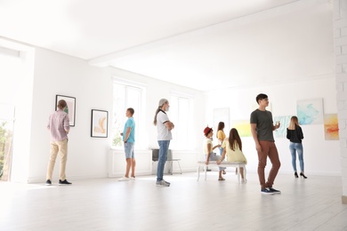 Photo of Group of people at exhibition in art gallery