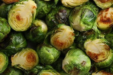 Photo of Delicious roasted Brussels sprouts as background, top view