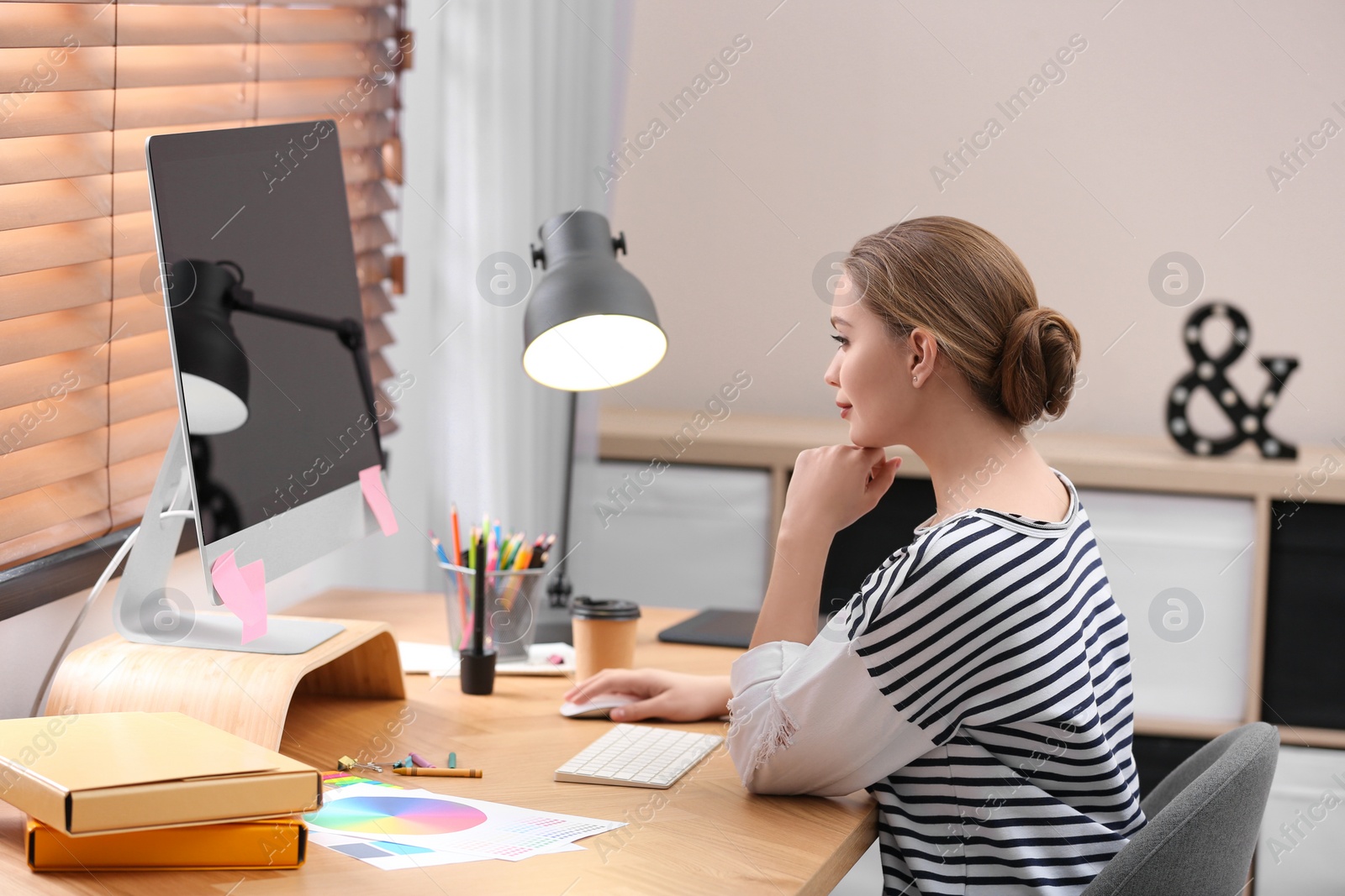 Photo of Female designer working at desk in office